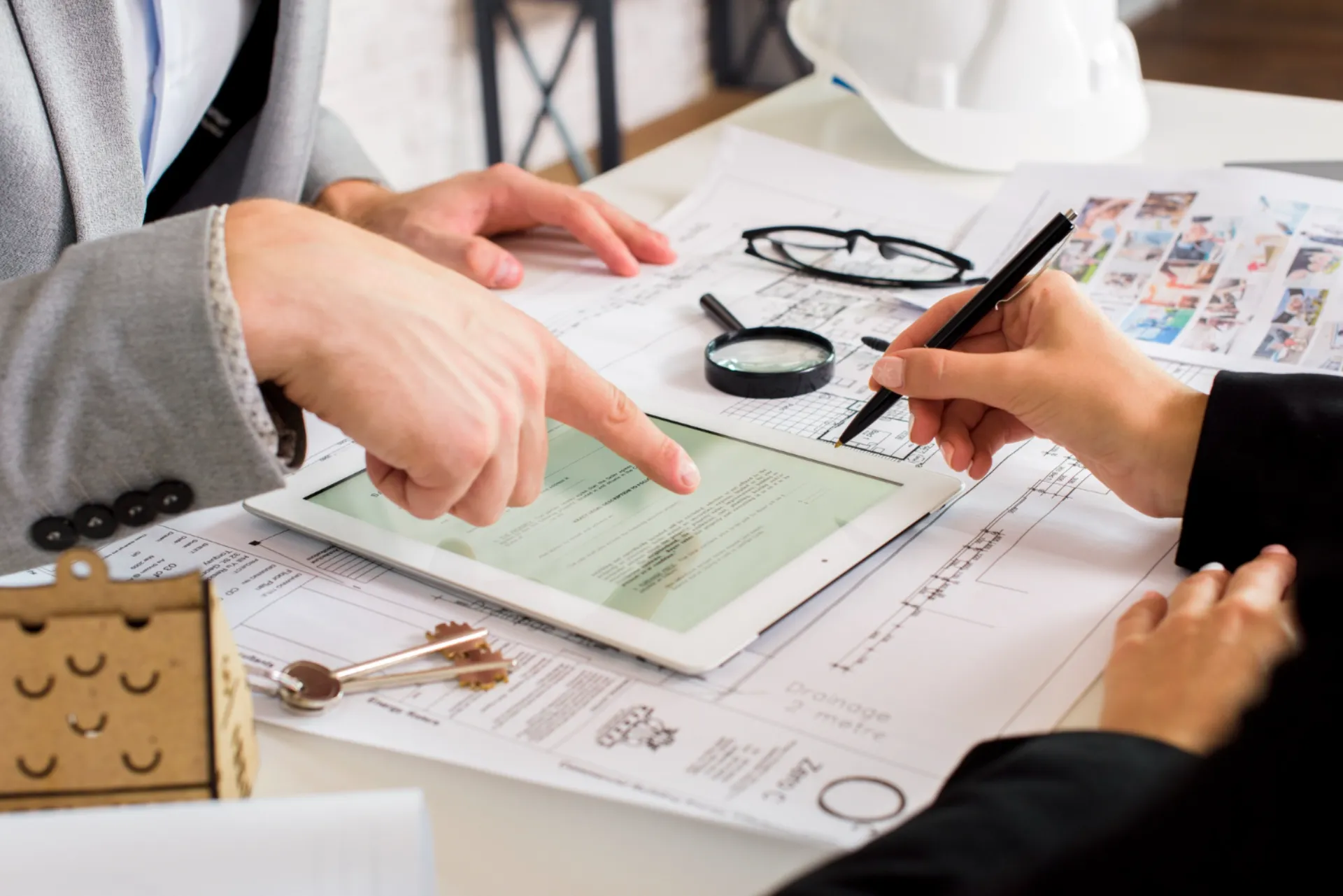 Construction professionals reviewing building permit documents and project plans in Ontario managed by Legacy Prime Construction